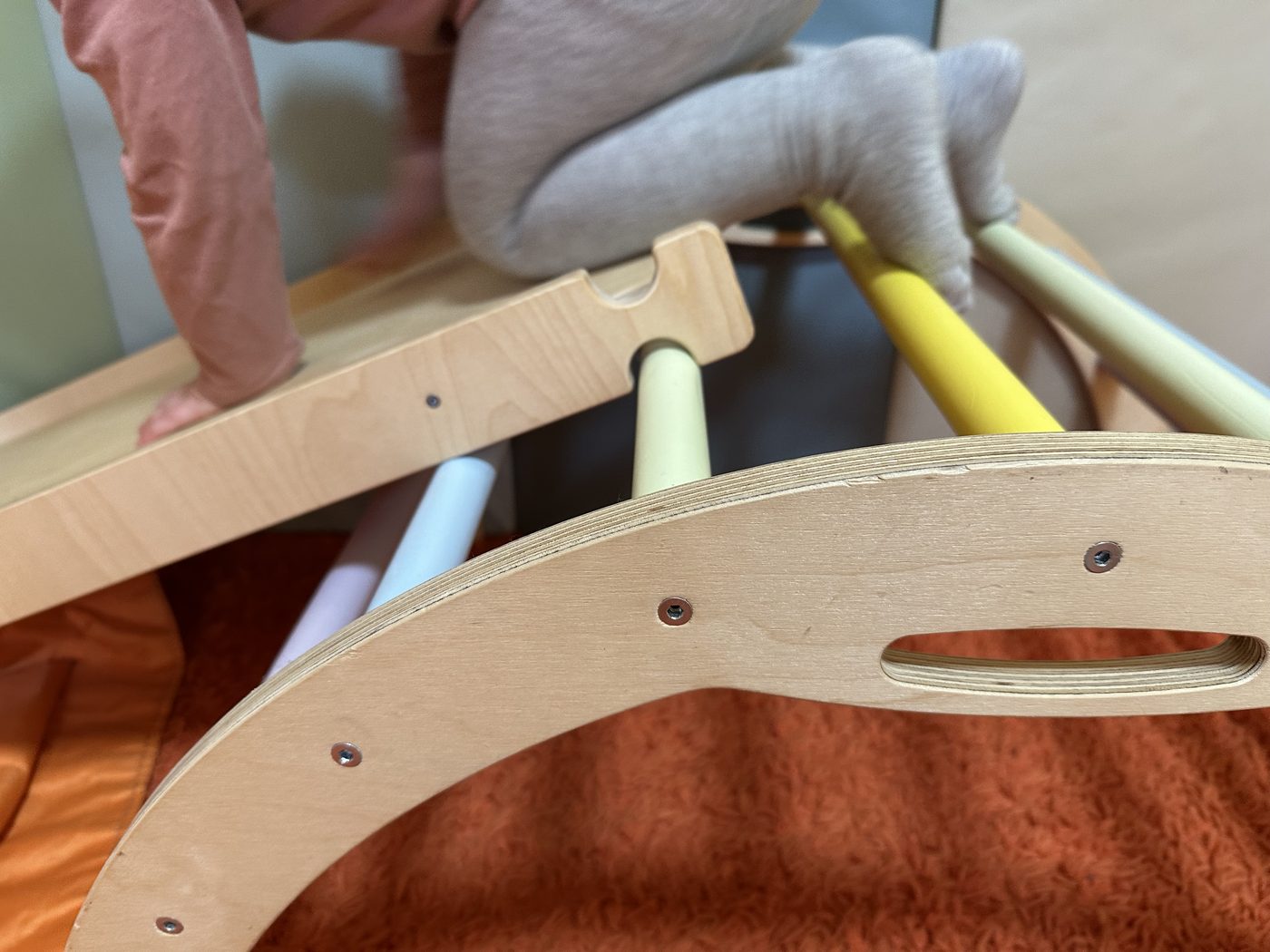 Kind klettert auf Pikler-Dreieck im Spielzimmer